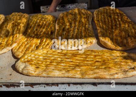 Yellow baked Barbari bread,one of the thickest flat breads,  on the food stall in Shirazi, Iran Stock Photo