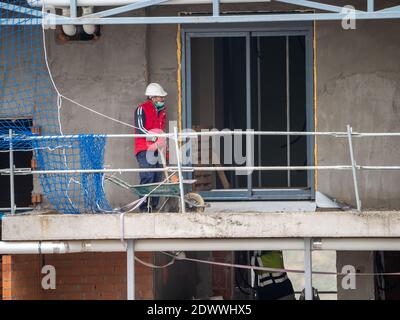 November, 16 2020, in Madrid, Spain, one construction worker is doing his job Stock Photo