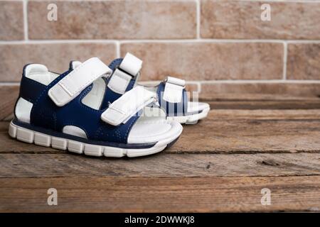 Colorful child sandals on wooden background Stock Photo