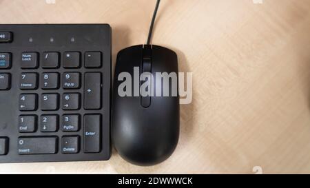 A workspace of an office which include mouse keyboard and wooden table Stock Photo