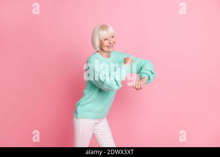 Full length body size photo of happy grandmother dancing cheerfully on weekends relaxing chilling isolated on pastel pink color background Stock Photo