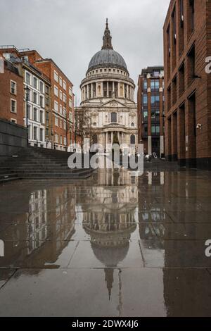 St. Paul's Cathedral reflects on the pavement on a rainy day in London. Stock Photo