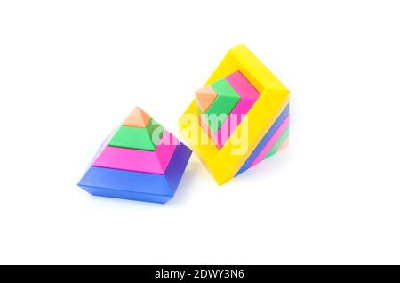 Children's educational toy for the development of motor skills, multi-colored pyramids, on a white background. Stock Photo