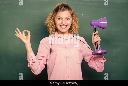 Educational idea. Knowledge day. Enlightenment concept. Creativity and inspiration. Light up process of studying. Insight and idea. Teacher hold table lamp chalkboard background. Bright shiny idea. Stock Photo