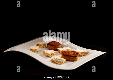 Assortment of Spanish Christmas sweets made up of Alicante nougat and polvorones. Stock Photo