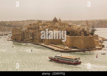 Fort Saint Michael, and Captain Morgan tour boat in Grand harbour, Senglea, Valletta region, Malta Stock Photo