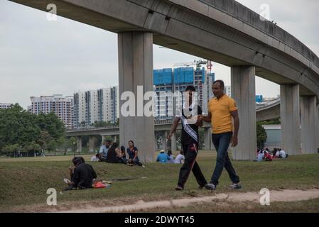 Foreign Bangladeshi migrant workers relaxing on their Sunday day off in Singapore Stock Photo