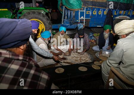 a group sikh farmer making food during the protest at singhu border ...