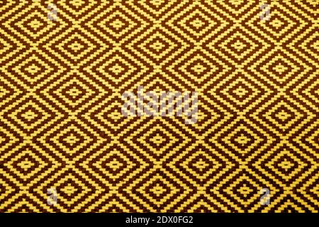 Yellow and Brown Geometric Pattern of Ethnic Fabric for Abstract Background Stock Photo