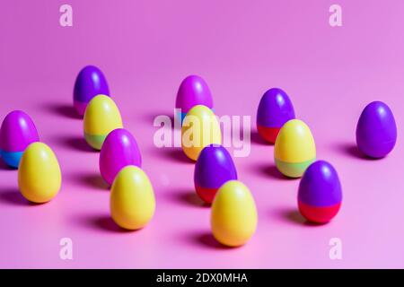 Colorful Plastic Easter Eggs on pink background Stock Photo