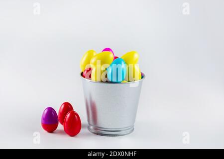 Colorful Plastic Easter Eggs in a metal bucket on white background Stock Photo