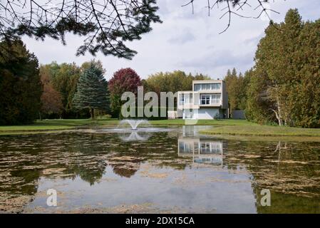 Residential building with a pond in the back yard. Stock Photo