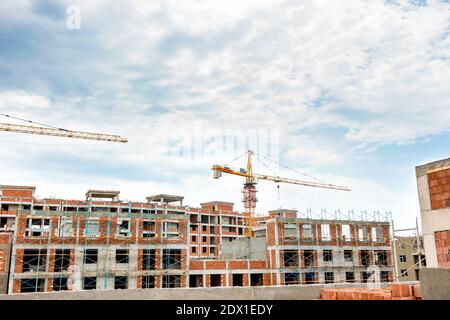 High buildings scaffold with crane at the construction site, top view Stock Photo