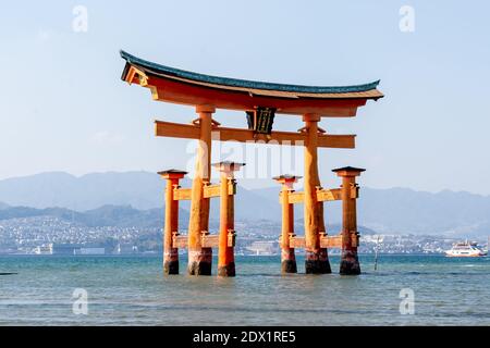 Floating torii gate in the water at Itsukushima Shrine (gate sign reads Itsukushima Shrine)in Hiroshima, Japan. Stock Photo