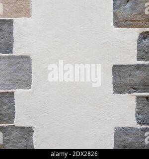 Plastered wall with stones on the sides Stock Photo