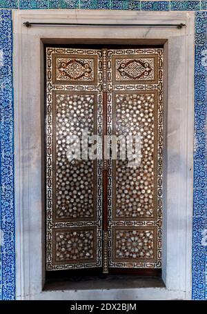 Elements of antique mosaic or architectural decorations on wooden shutters of oriental palace, texture or decorative element of oriental pattern in tu Stock Photo