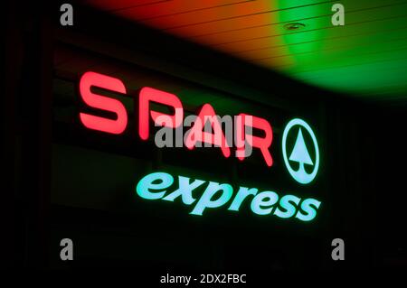 Lugano, Ticino, Switzerland - 27th November 2020 : Luminous Spar Express supermarket sign hanging on a store in Lugano. SPAR is a Dutch multinational Stock Photo