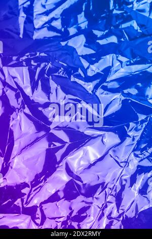 Neon crumpled textured holographic trendy dark background Stock Photo