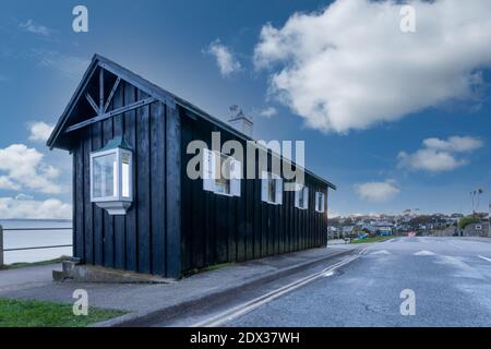 old beach huts on Falmouth sea front with blue skies and clouds cornwall England uk Stock Photo