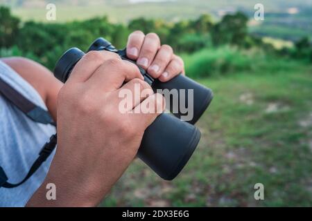 Closeup of male hands with binoculars Stock Photo