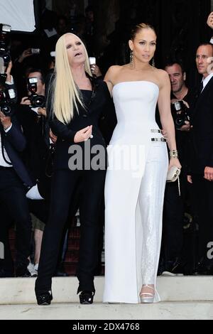 Donatella Versace and Jennifer Lopez attending Versace's Fall-Winter 2014/2015 Haute Couture collection show held at the Salon de la Chambre de Commerce et de l'Industrie in Paris, France, on July 06, 2014. The international sensation was absolutely a vision in a preview of the Atelier Fall 2014 collection: she wore a strapless pure white Atelier Versace gown with thigh high slit and one fully beaded pant leg, accented with two metallic straps on the hip, which were a key component of the new collection. Photo by Aurore Marechal/ABACAPRESS.COM Stock Photo