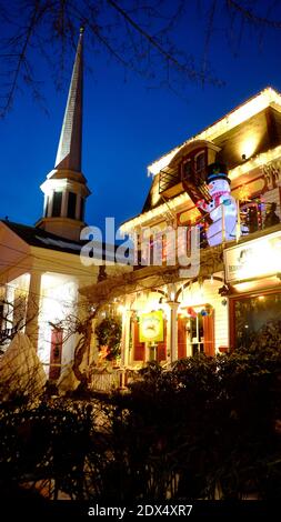 Woodstock, NY. Colonial home decorated for Christmas with Woodstock Reformed Church on left Stock Photo