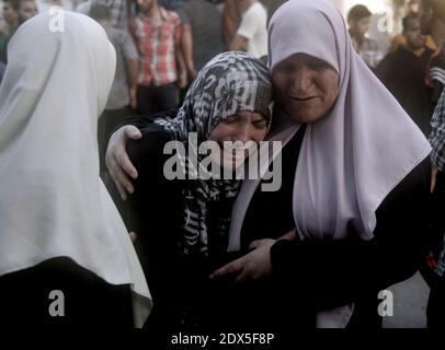 Relatives of a Palestinian, whom medics said was killed by Israeli shelling near a market in Shejaia, mourn at a hospital in Gaza City July 30, 2014. Israeli strikes near a market in the eastern Gaza Strip killed 15 Palestinians on Wednesday, the local health ministry said. Residents said that Israeli shelling and two missiles from the air hit the area in Shejaia, on the fringes of the city of Gaza. Ashraf al-Qidra, spokesman of the Gaza Health Ministry, said 160 people were also wounded. An Israeli military spokeswoman said she was checking the report. Israel launched its offensive in respons Stock Photo
