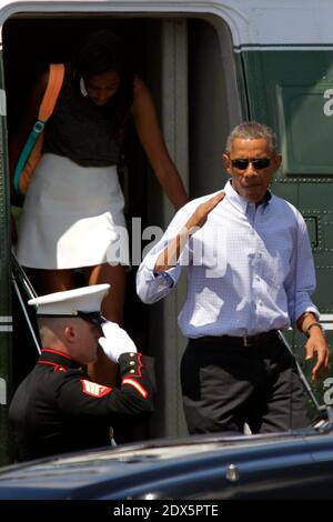 President Barack Obama returns a salute as he boards Marine One at ...