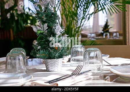 Beautifully decorated Christmas tree with dining table set up Stock Photo