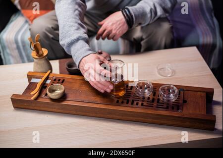 Recipe for creating delicious black tea according to chinese traditions. Close-up set of glass and clay dishes for tea. Flasks and kettle Stock Photo