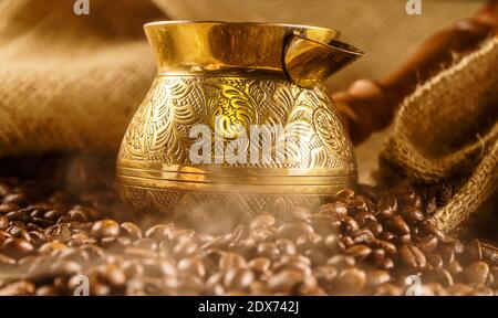 Golden cezve with freshly roasted coffee. Stock Photo