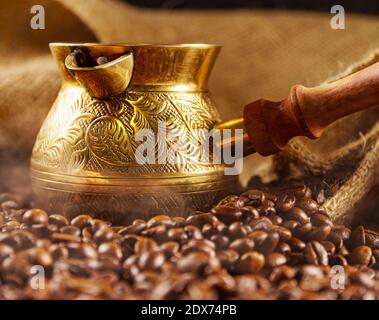 Golden cezve with freshly roasted coffee. Stock Photo