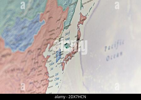 Photo of the map with pinned city of Tokyo. Pin in the map, Tokyo, Japan, english map, soft colours, view from south east, visible China and Pacific. Stock Photo