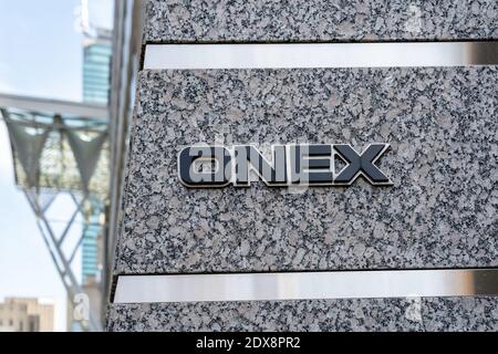 Sign of Onex Corporation outside their head office with blurred Brookfield Place entrance in downtown Toronto, Canada Stock Photo
