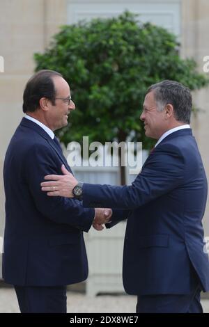 Jordan's King Abdullah II, right, is greeted by French Prime Minister ...