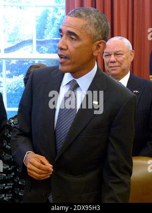 US President Barack Obama, with America's Promise Alliance Founding Chairman and former US Secretary of State General Colin Powell (R), responds to a question from the news media after signing the America's Promise Summit Declaration during a ceremony in the Oval Office of the White House in Washington, DC, USA, September 22, 2014. President Obama will be the seventh consecutive president to sign the declaration, which calls on Americans to help the youth of America reach their full potential. Photo by Shawn Thew/Pool/ABACAPRESS.COM Stock Photo