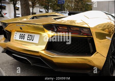 A gold Lamborghini Aventador is parked outside the Plaza Athenee palace hotel on the luxury Avenue Montaigne as the fashion week starts today, in Paris, France, September 24, 2014. Photo by ABACAPRESS.COM Stock Photo