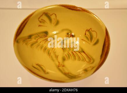 An ancient bowl with flying bird figure in the bottom showed in the museum in Shanghai Stock Photo