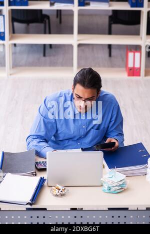 Young bookkeper in budget planning concept Stock Photo