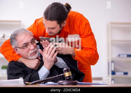 Old judge meeting with young captive in courthouse Stock Photo