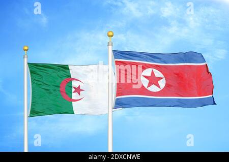 Algeria and North Korea two flags on flagpoles and blue sky Stock Photo