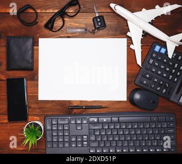 White sheet on dark wooden office desk table with a lot of supplies Stock Photo