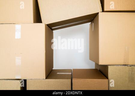 Stack of cardboard boxes against wall Stock Photo
