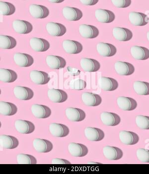 Pattern of white chicken eggs against blue background Stock Photo