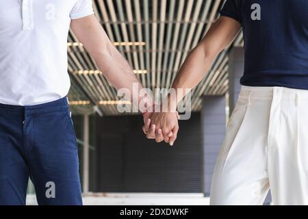 Homosexual couple holding hands in city Stock Photo