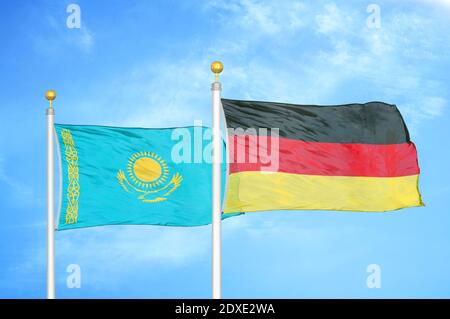 Kazakhstan and Germany two flags on flagpoles and blue sky Stock Photo