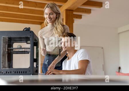 Expertise team working together on 3D printer at home Stock Photo
