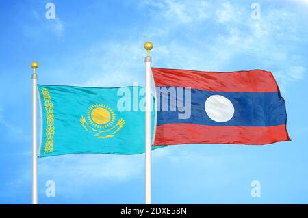 Kazakhstan and Laos two flags on flagpoles and blue sky Stock Photo