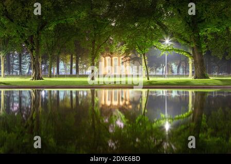 USA, Washington DC, Trees reflecting in Lincoln Memorial Reflecting Pool at night with District of Columbia War Memorial in background