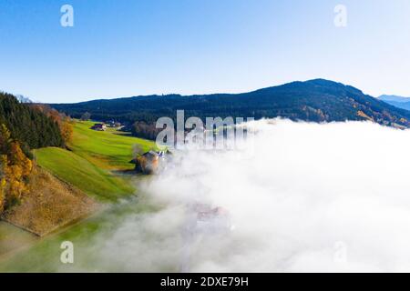 Drone view of mountain valley shrouded in thick fog Stock Photo